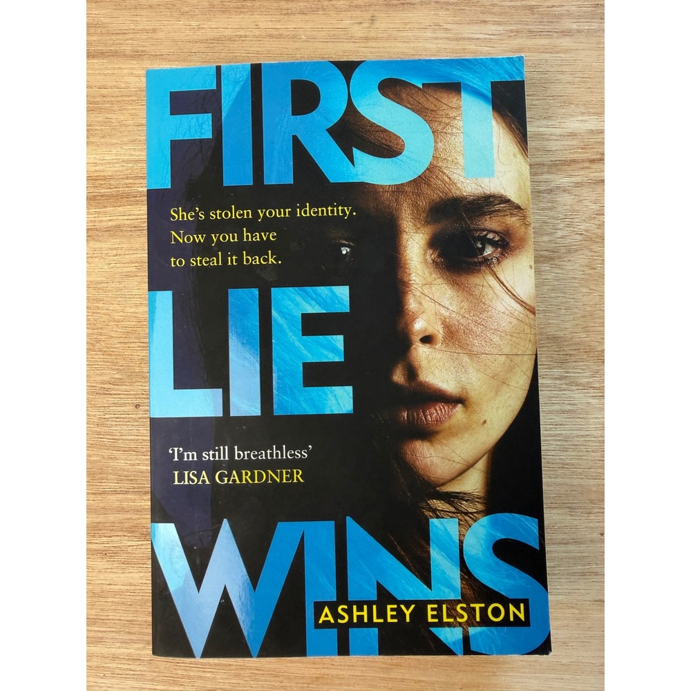 ASHLEY ELSTON First Lie Wins Novel Paperback Blue Black Thriller Fiction Book